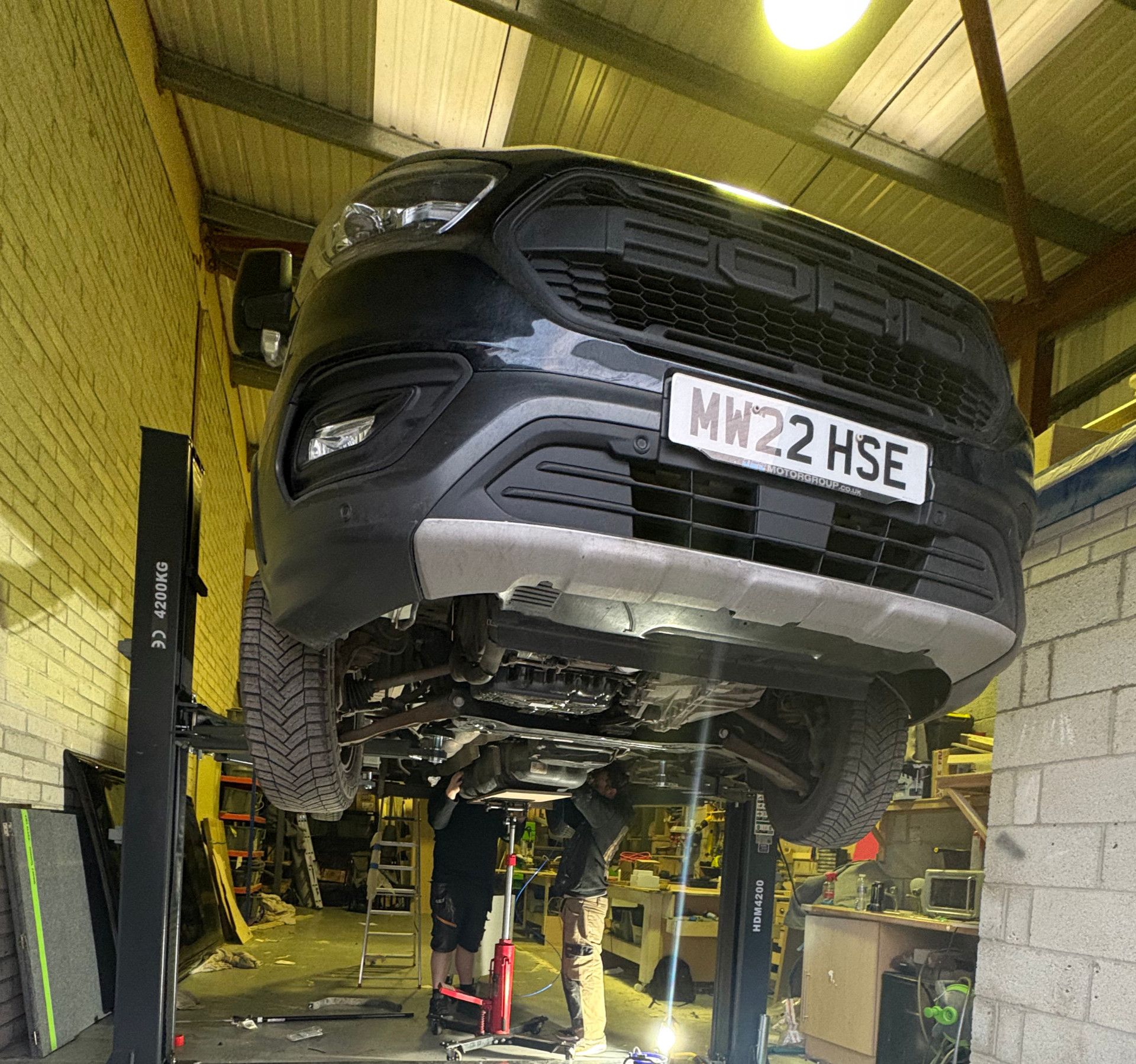 Diesel heater being fitted under a van