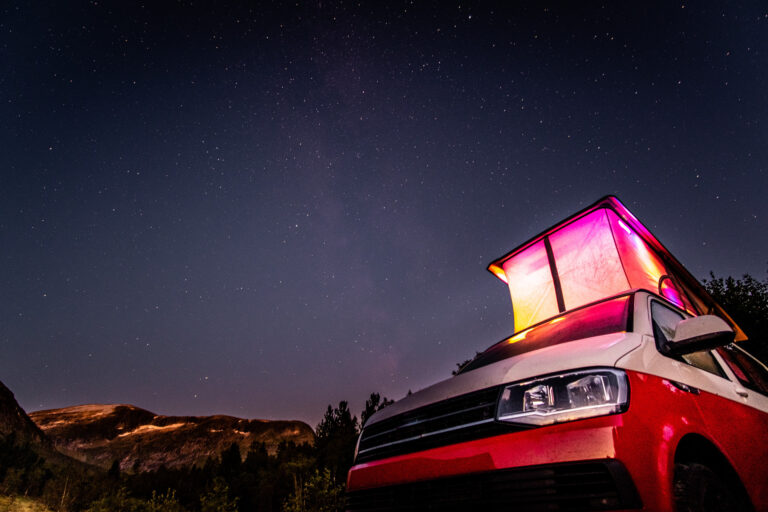 Campervan with Skyline pop top roof lit up at night