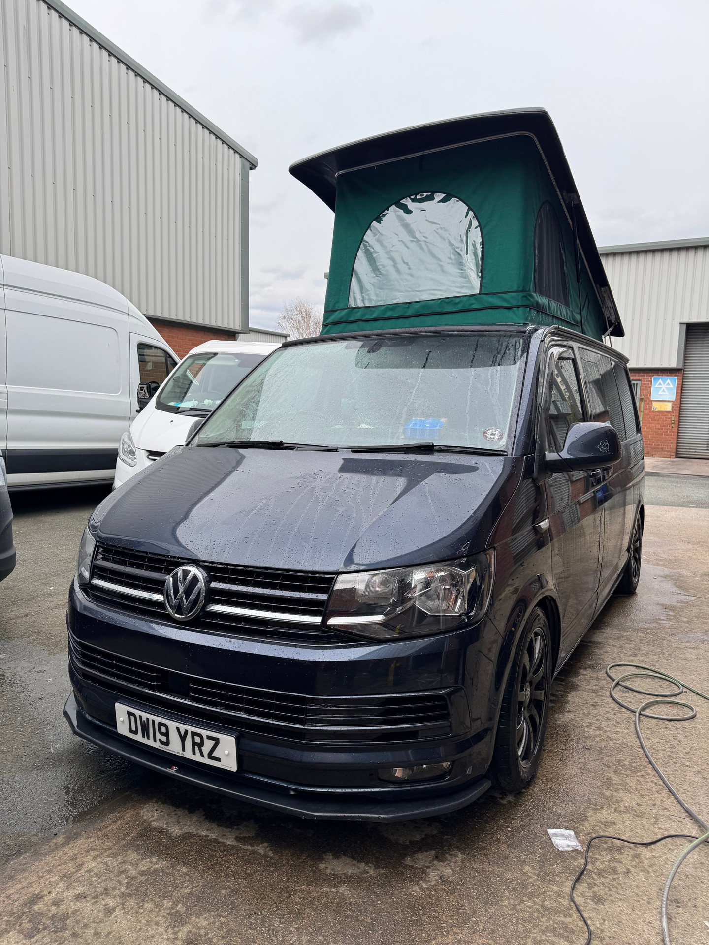 Black VW T6 with pop top roof