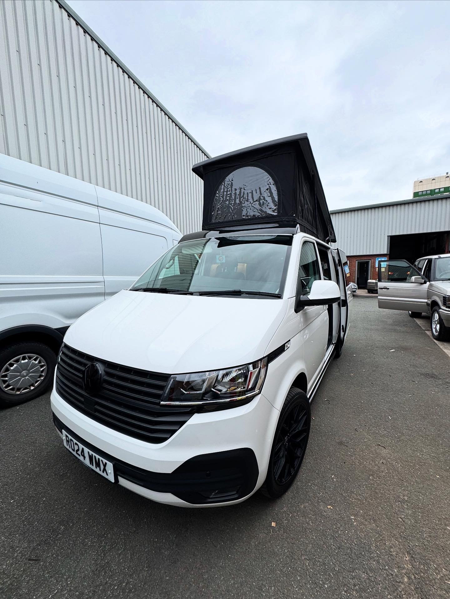 White VW T6 with pop top raised